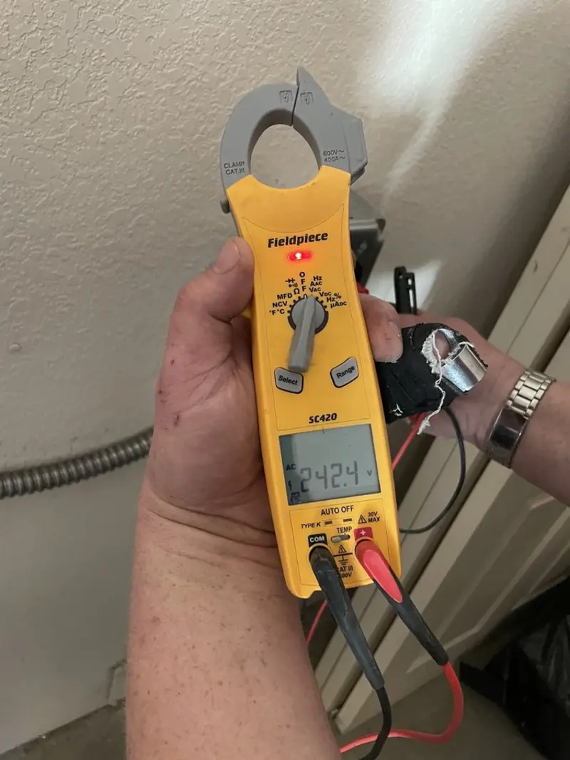 Voltage testing with clamp meter during Electrical Installation Services in McPherson